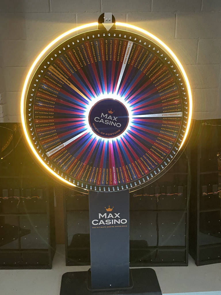 Illuminated prize wheels and spinning wheel games
